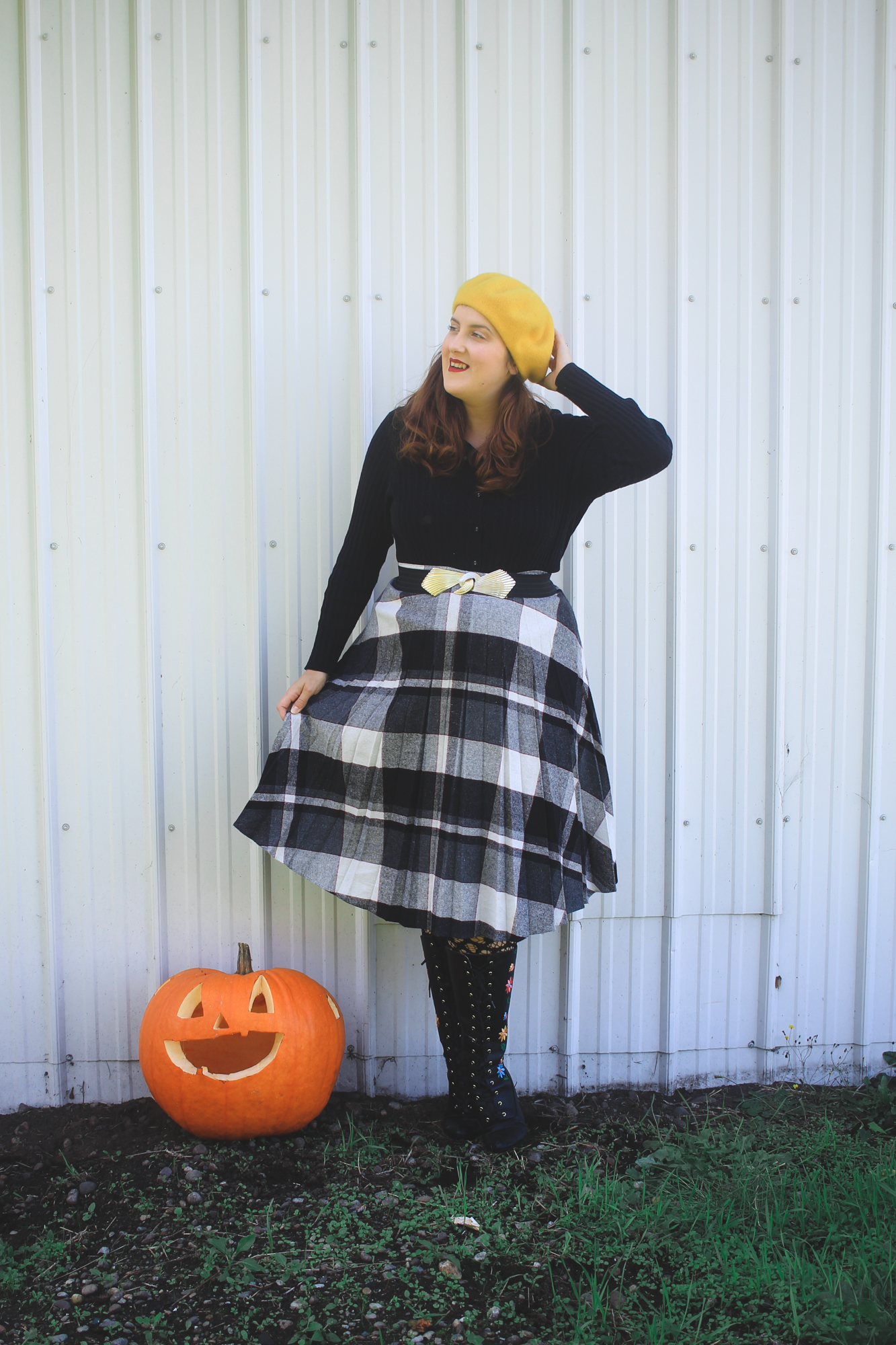 woman wearing a yellow beret and a plaid skirt